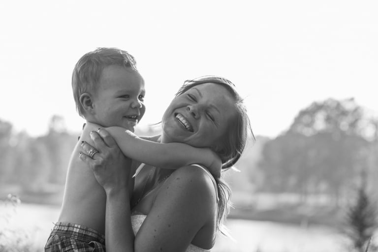 black and white portrait of mom and son having a giggle