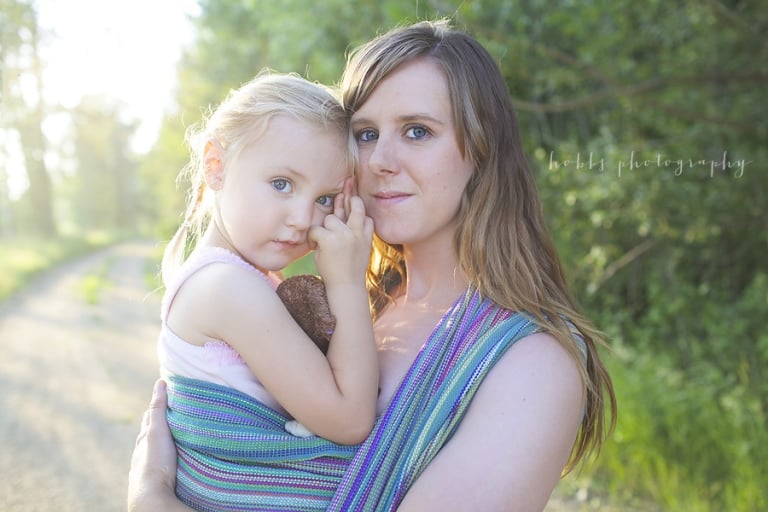 spruce grove mom wears her daughter in woven wrap