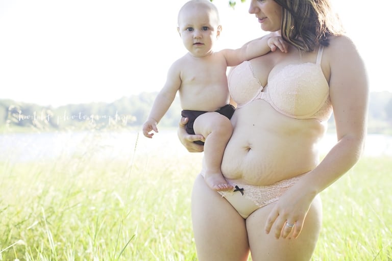 mom with stretchmarks holds her baby