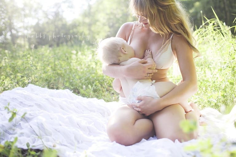 first time mom breastfeeds her infant