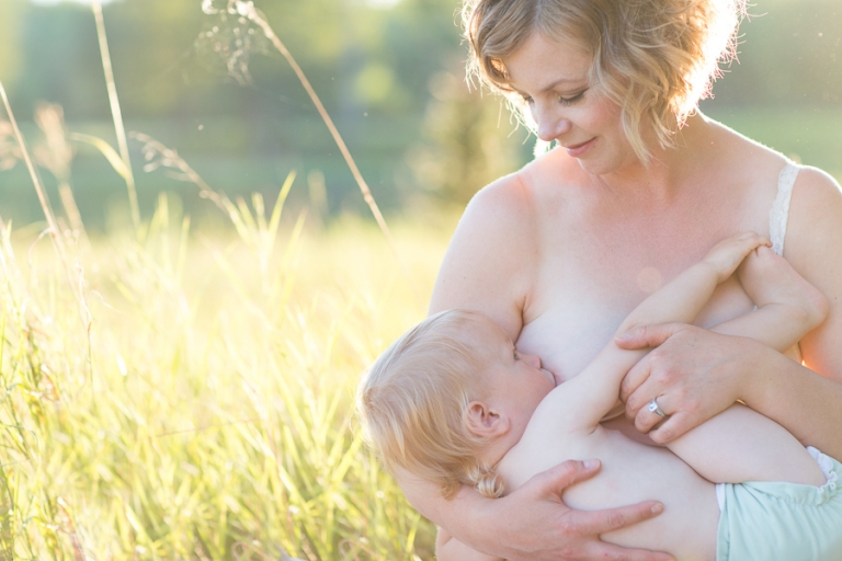 beautiful mother breastfeeds her cloth diapered son