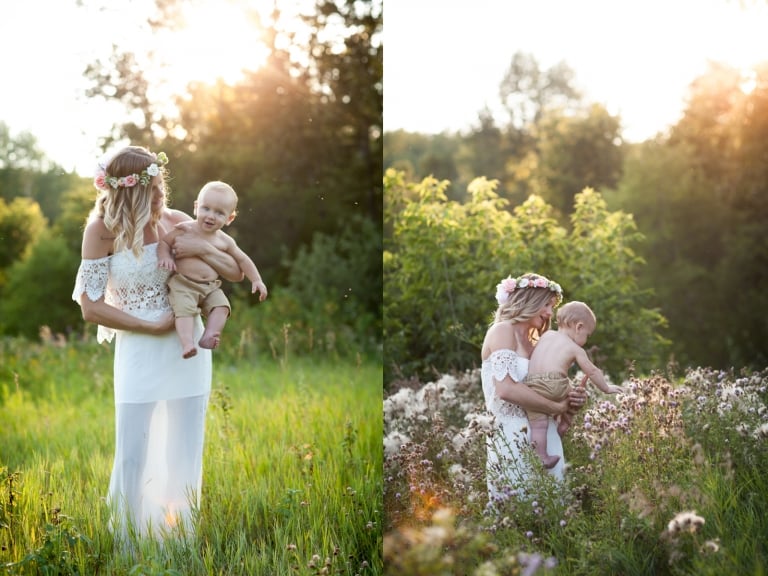 toddler touches thistle down while being held by his mother