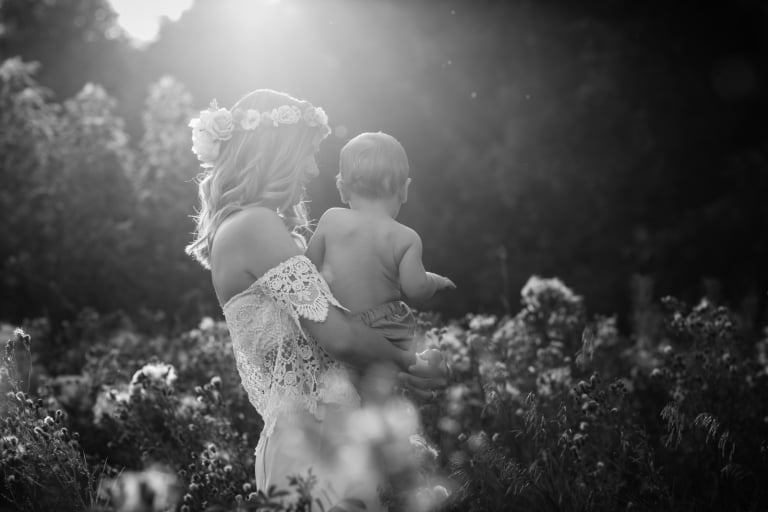 black and white portrait of mom and kid amongst the thistles