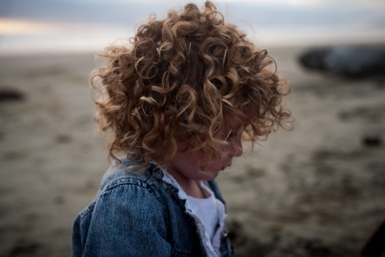 Edmonton family photography captures the detail of a child's curly hair during lifestyle photos