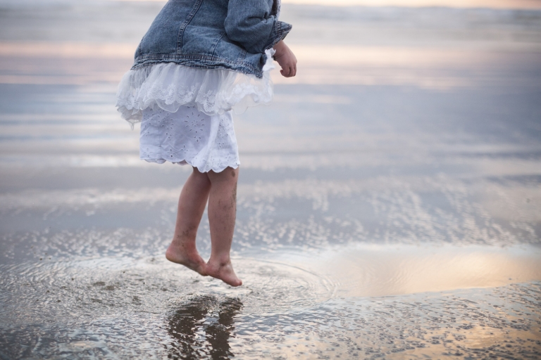 photographs of kids being kids means jumping in puddles