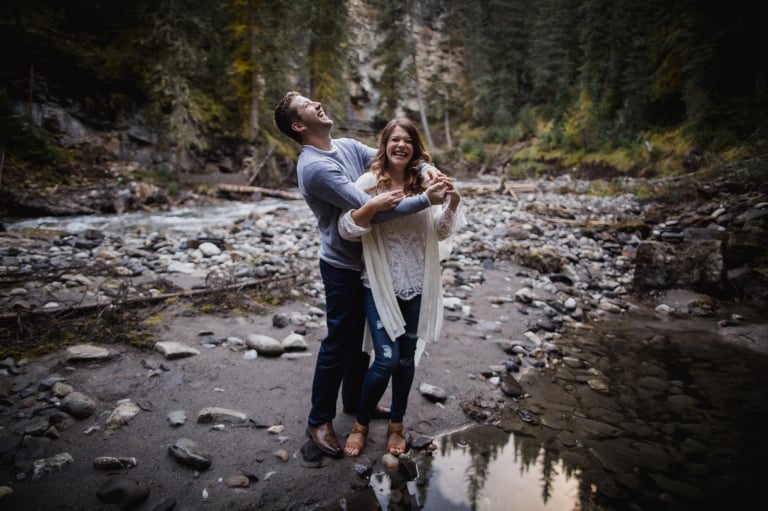 couple laughs during their engagement pictures in Banff National Park