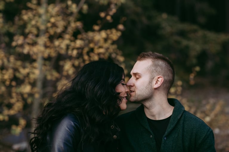 couple kiss during fall Banff engagement photos