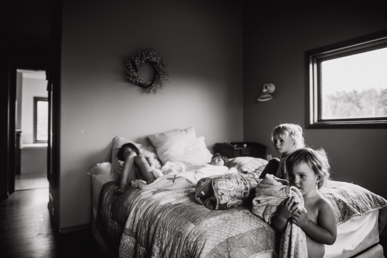 kids hang out in mom and dad's bedroom as mom begins to labour