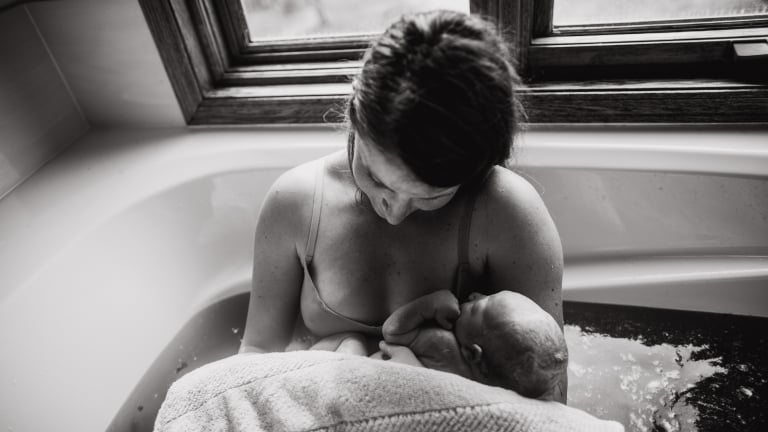 mom holds baby immedately after giving birth in her home