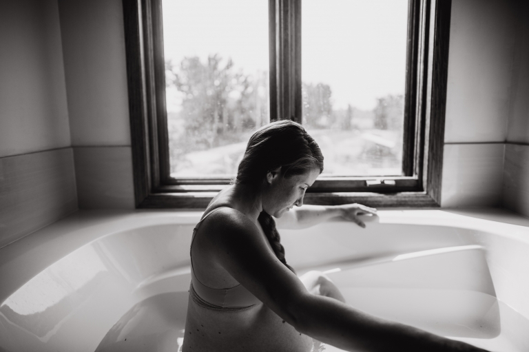 Jenna Hobbs sits in the tub of her Parkland County farmhouse while she labours with her fifth child