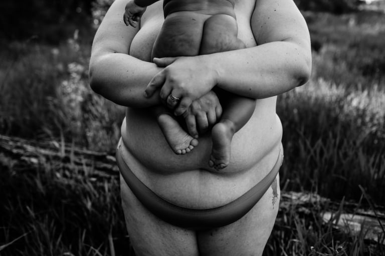 a squishy baby bum held in his mother's arms