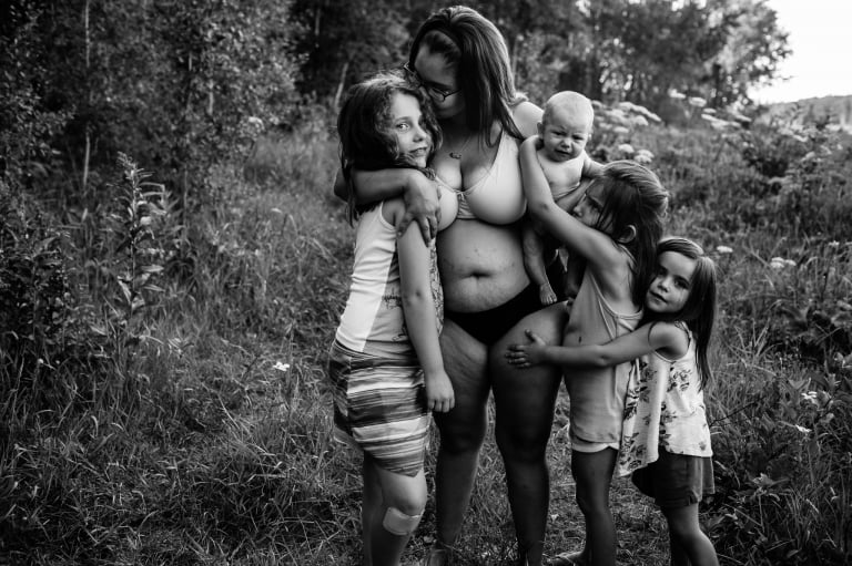 a mother of four holds her four daughters close