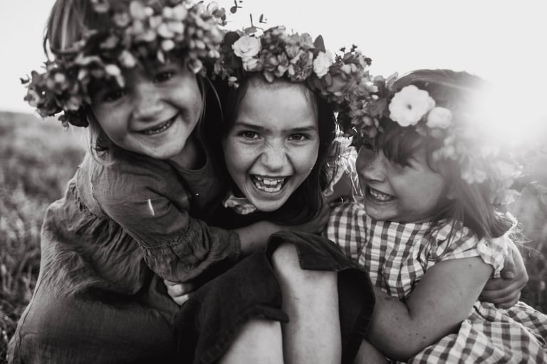 sisters wear flower crowns made by Wyld Chickadee during beautiful lifestyle family session near Edmonton