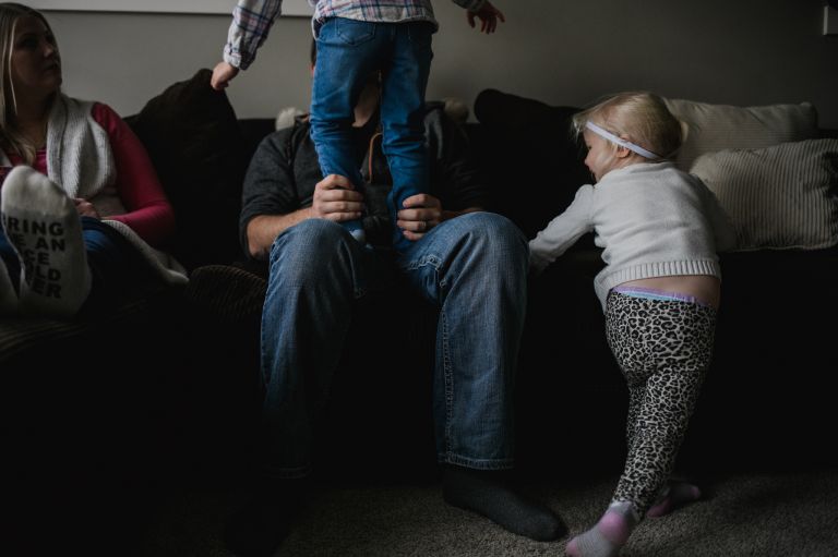 family of four in edmonton play in living room