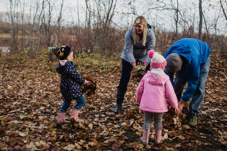 family throws fall leaves 