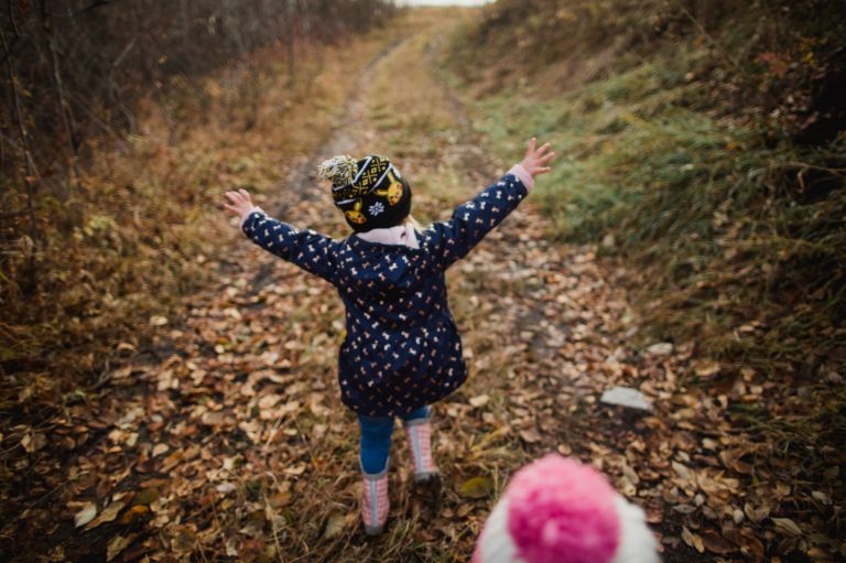 girl runs in leaves