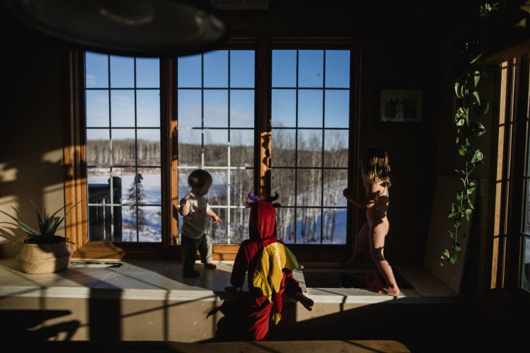 kids play in the house in front of window