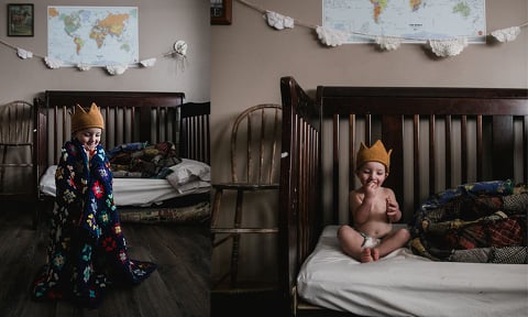 baby sits on his bed wearing crocheted crown