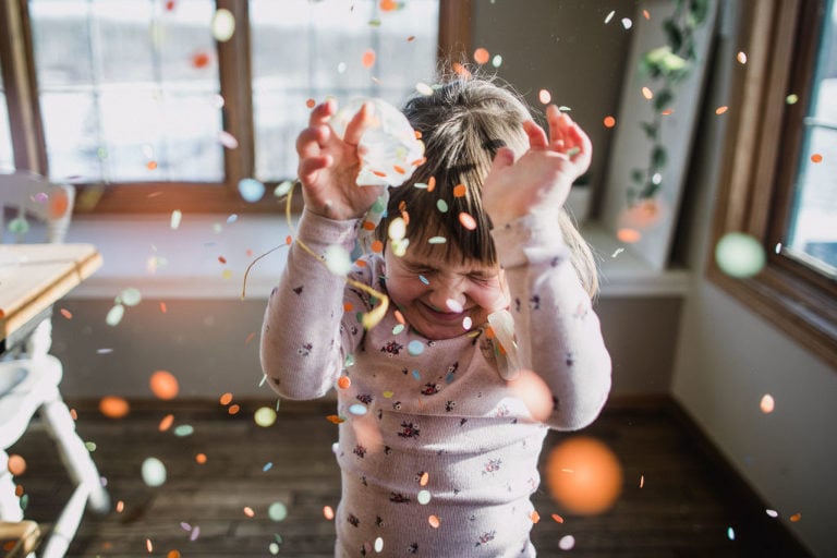 girl squeals as confetti rains down on her