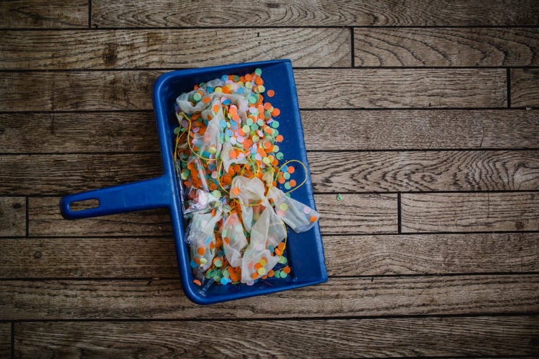 dust pan full of swept up confetti