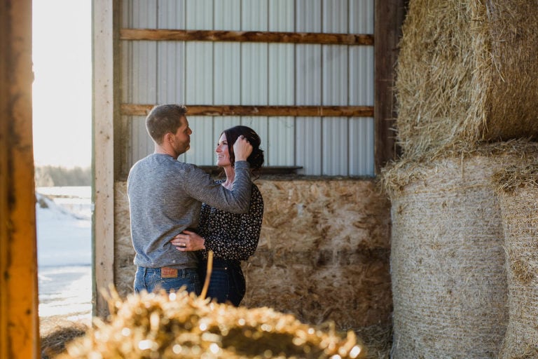 fiance brushes his love's hair from her face