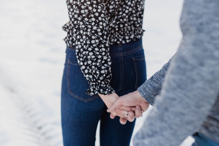 couple holds hands as they walk together