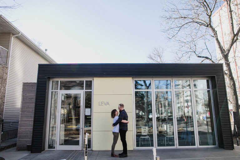 couple hugs in front of Edmonton building