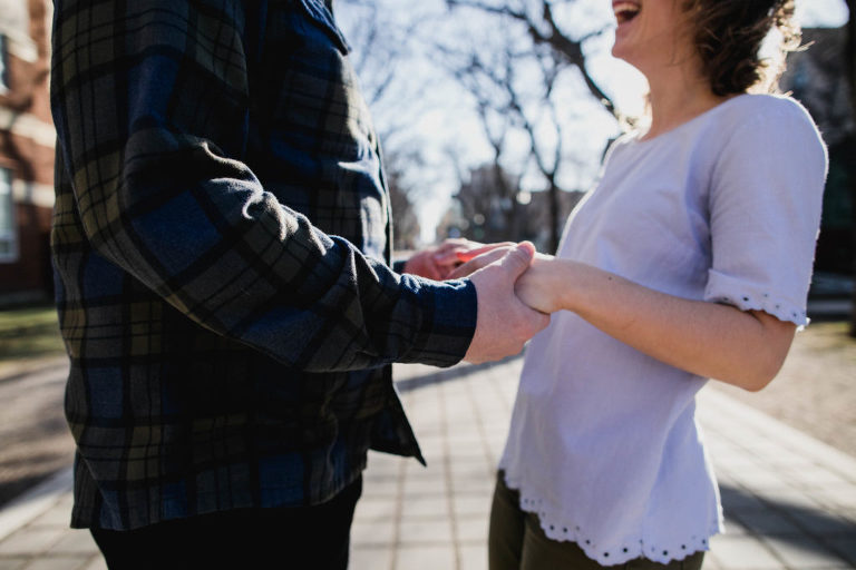 sweet moment holding hands during engagement photos