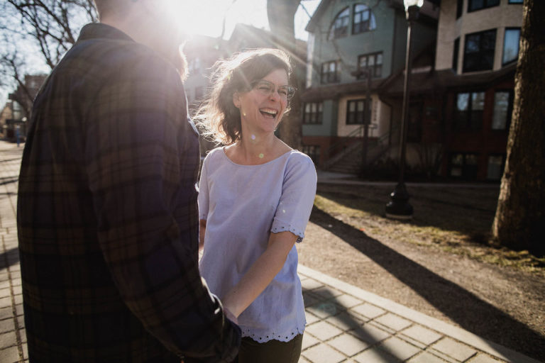 fiancee laughs in beautiful light during engagement pictures