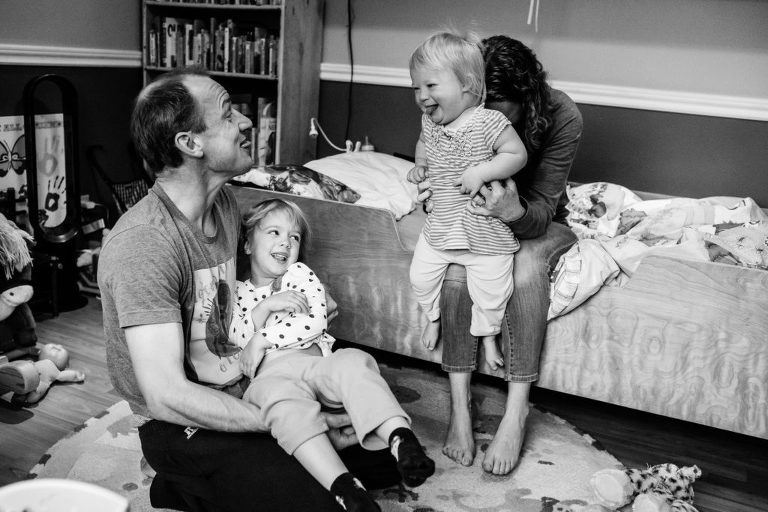 family of four play in the kids' bedroom during edmonton family photography session