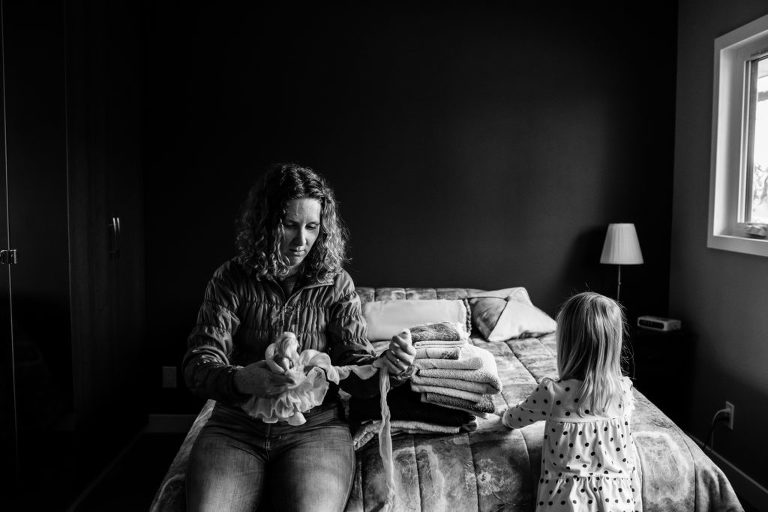 mom and daughter sit in grandmother's bedroom in Edmonton
