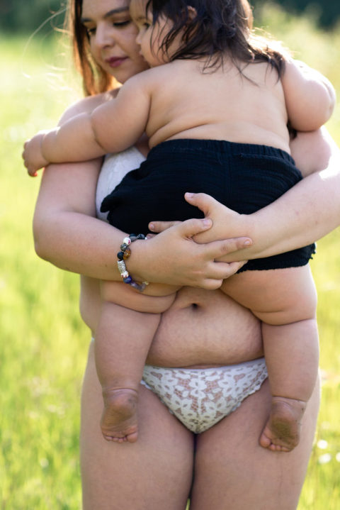 mom holds baby in arms for a mothers beauty series