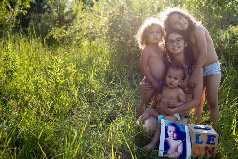 postpartum photography of a mom with her three living children